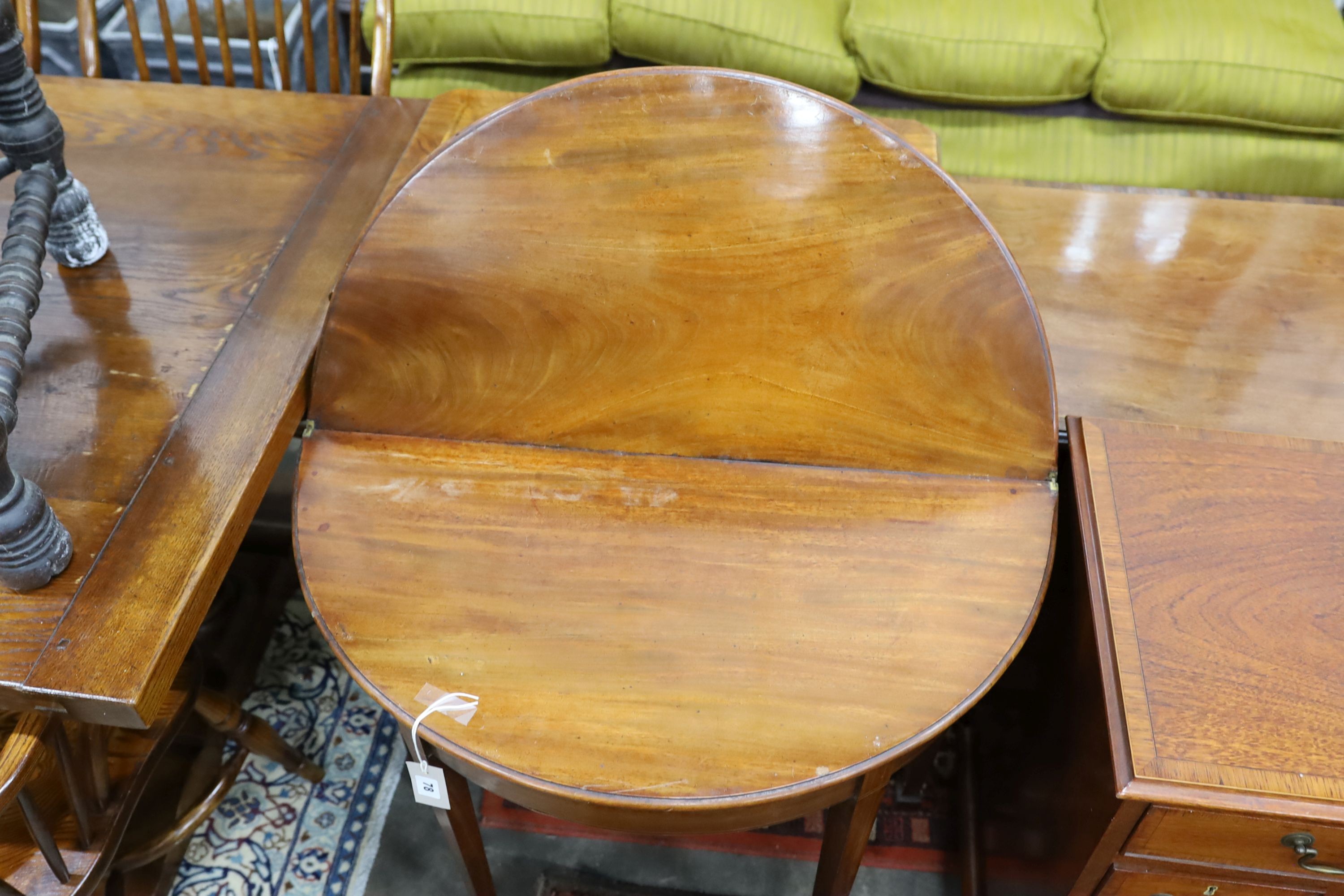 A George III mahogany D-shaped folding tea table, width 39cm, depth 80cm, height 73cm